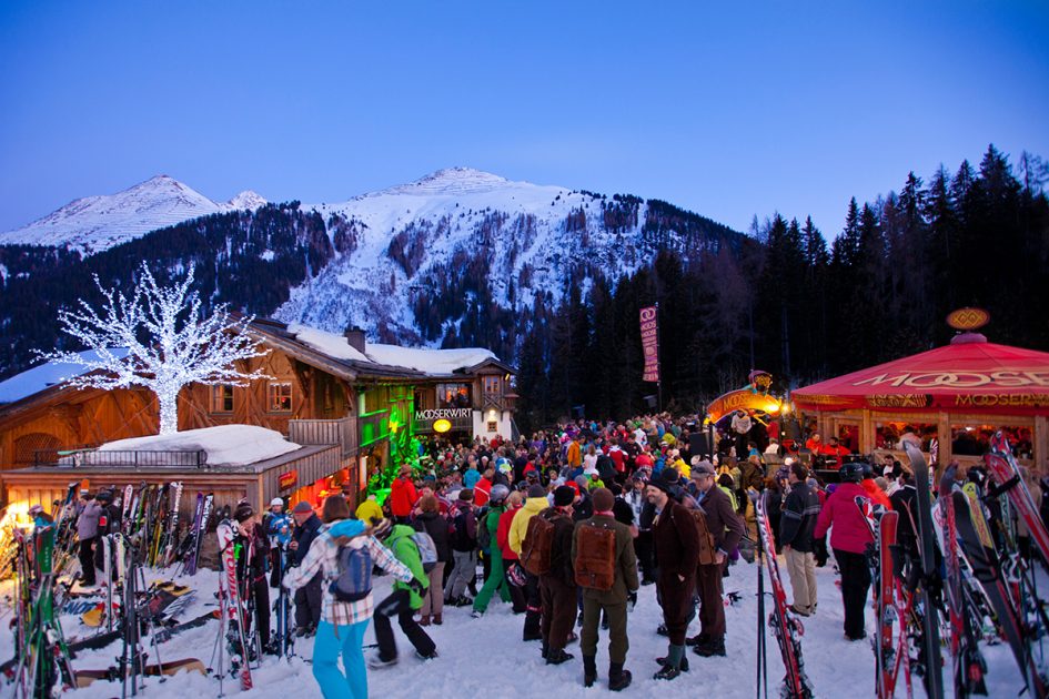 Revellers spilling out onto the slopes from the terrace at the après bar Mooserwirt, found on the slopes of St Anton.
