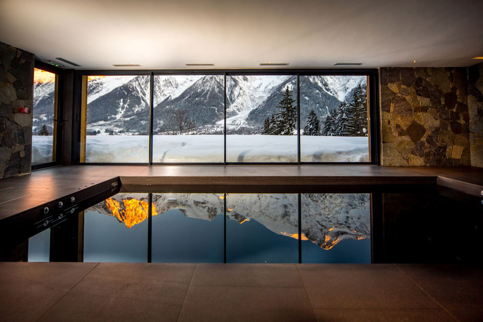 Indoor swimming pool at Le Chalet Mont Blanc with mountain views.