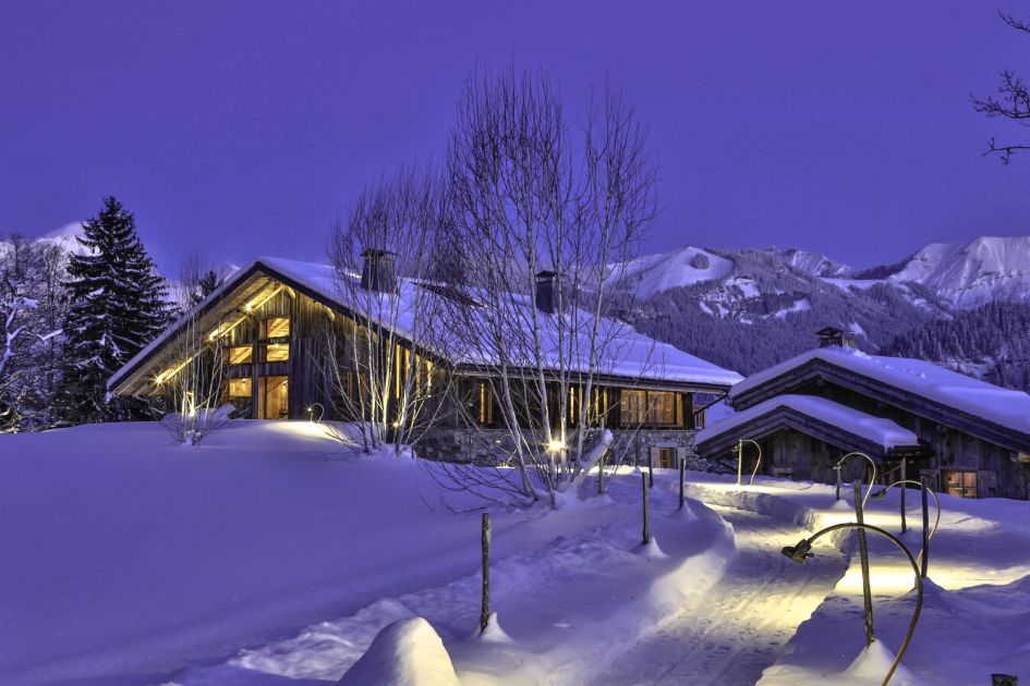 Fermes a la Leonthine lit up in the mountain dusk.