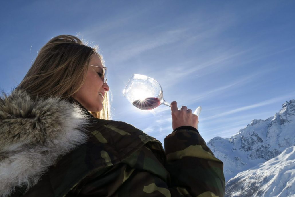 Lady drinking red wine in Cervinia on the mountains