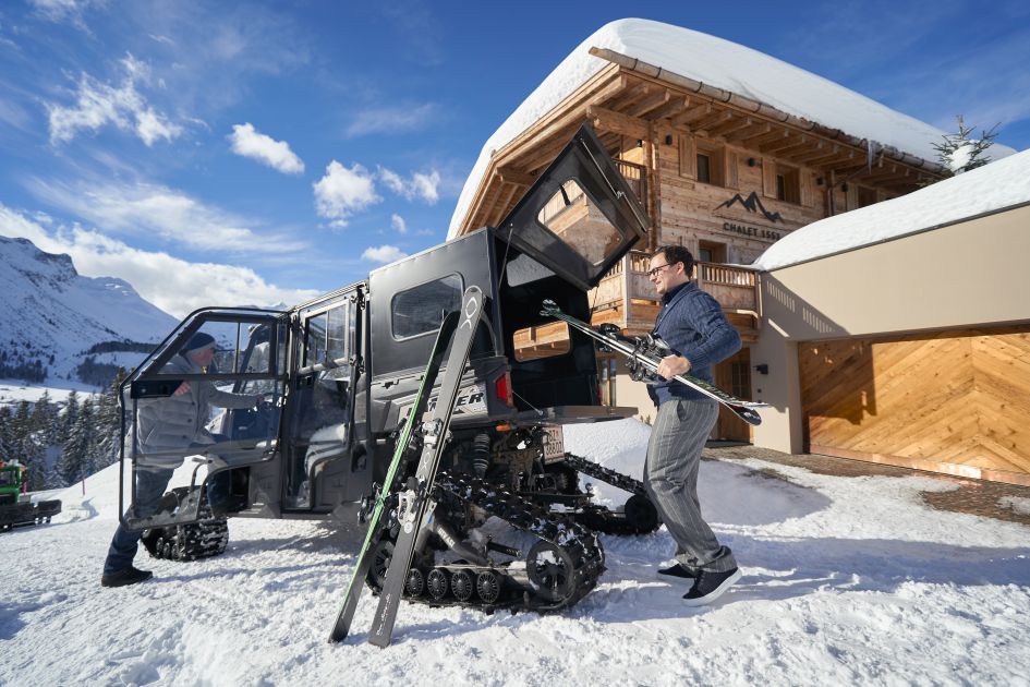 Staff at Chalet 1551 helping load guests equipment into their Polaris Ranger. All part of their luxury ski holiday experience and luxury skiing in Oberlech. , Lech, luxury chalets in Austria, Ski In/Ski Out Oberlech