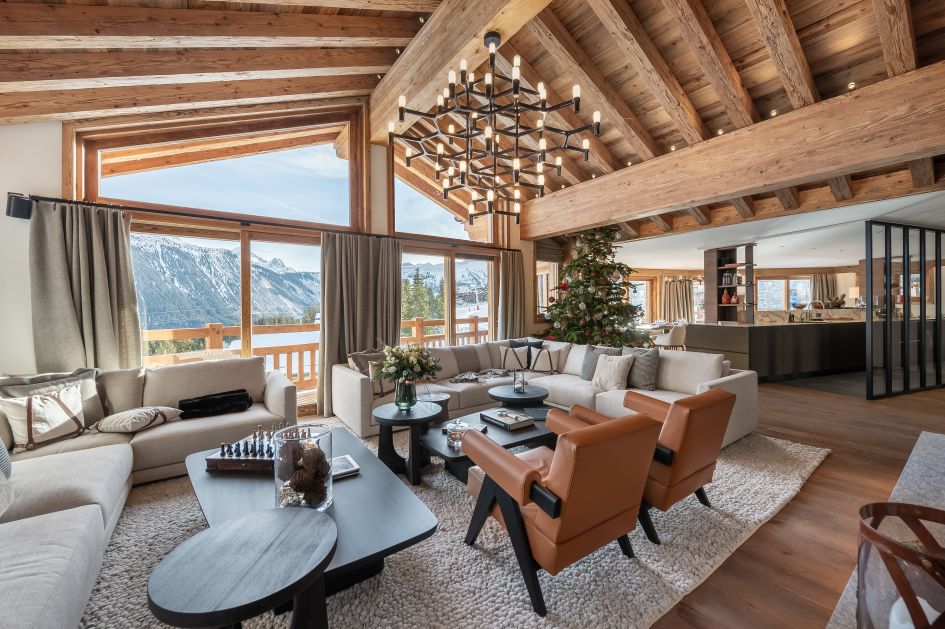 An image of Chalet Bruxellois' inviting, open plan living area with views strecthing out over the valley.