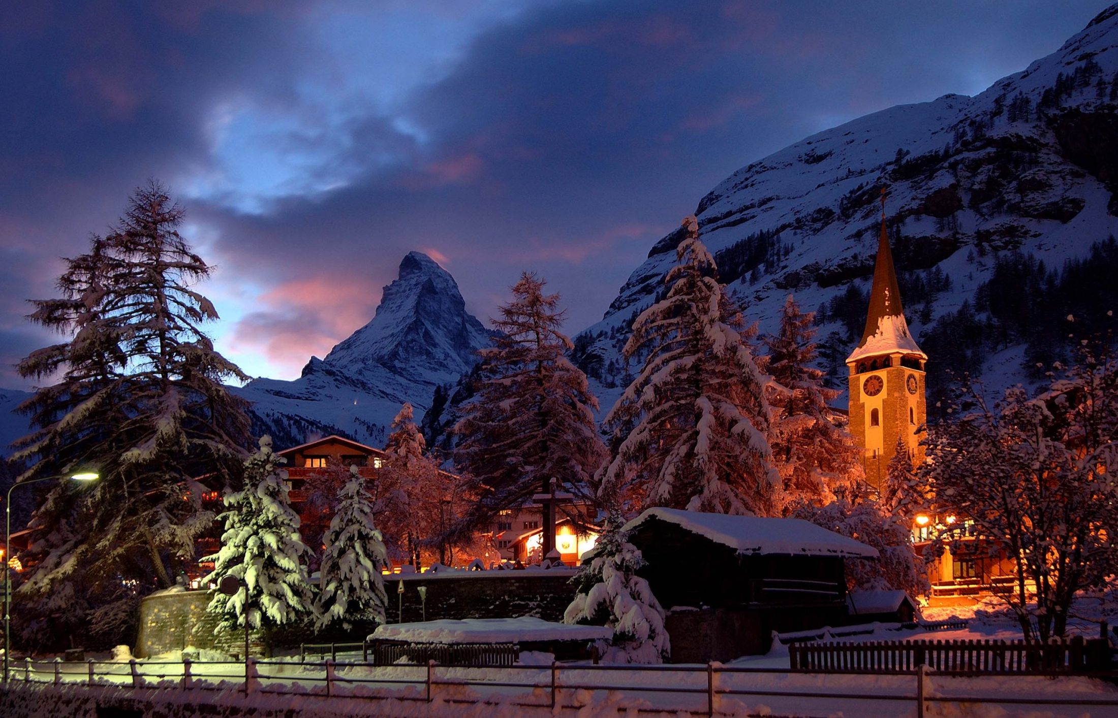 The centre of Zermatt displaying the iconic Matterhorn and church tower. A view desired by most luxury ski chalets in Zermatt.