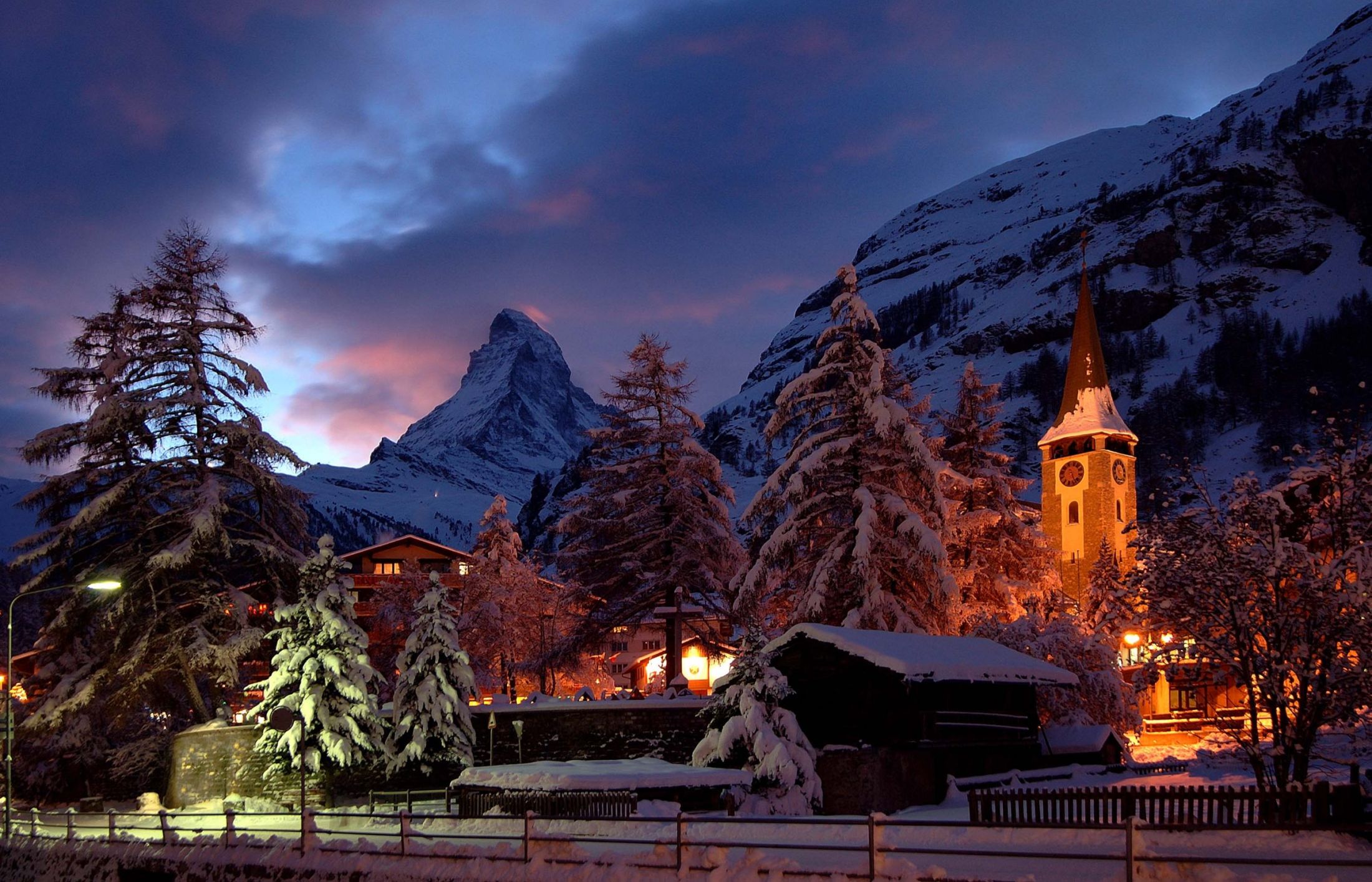 The centre of Zermatt displaying the iconic Matterhorn and church tower. A view desired by most luxury ski chalets in Zermatt.