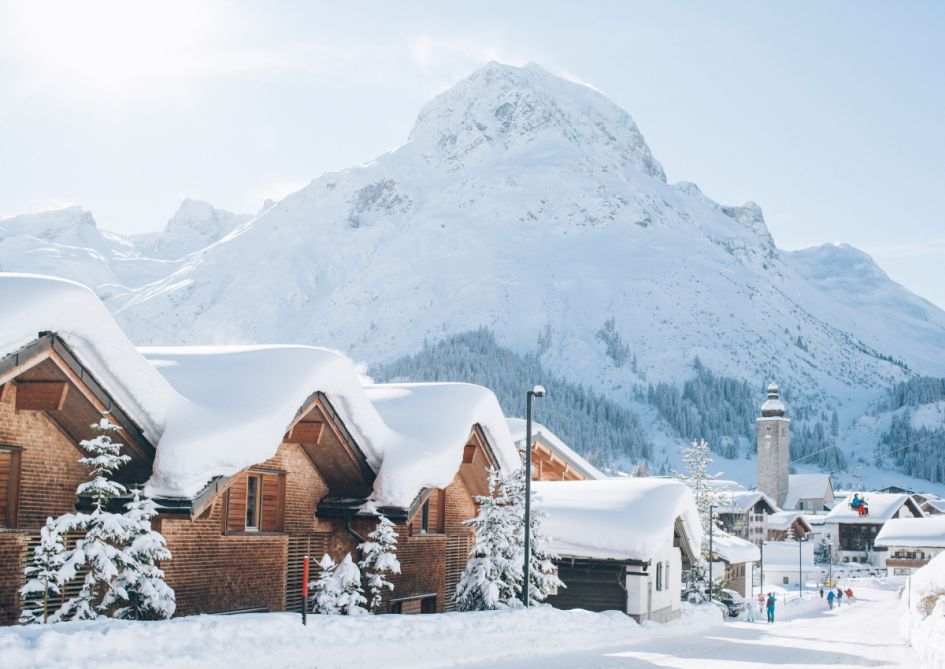 Snow laden roofs of luxury chalets in Lech for the picture perfect early season ski holiday. It is one of the best resorts for skiing in December