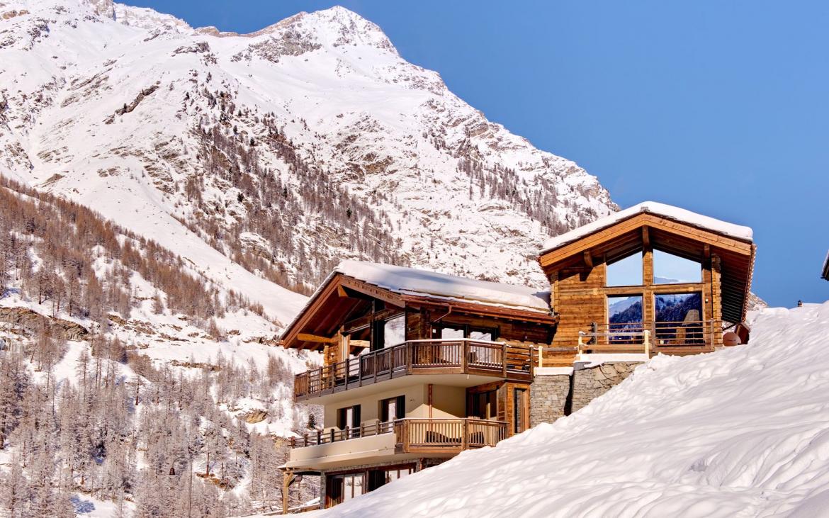 Chalet Grace, one of the best chalets for a ski holiday in the Swiss Alps. A mountain backdrop behind.