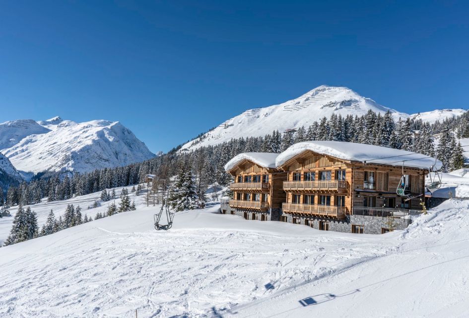 Arula Chalets' exterior with mountain views and a chairlift in the foreground showing the ski-in, ski-out access