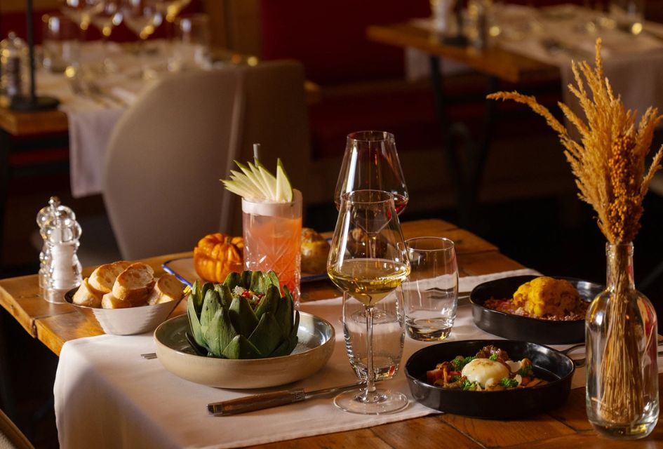 The Best Restaurants in Verbier. (L'Ecuire) L'Ecurie table setting with bread, three dishes, and drinks