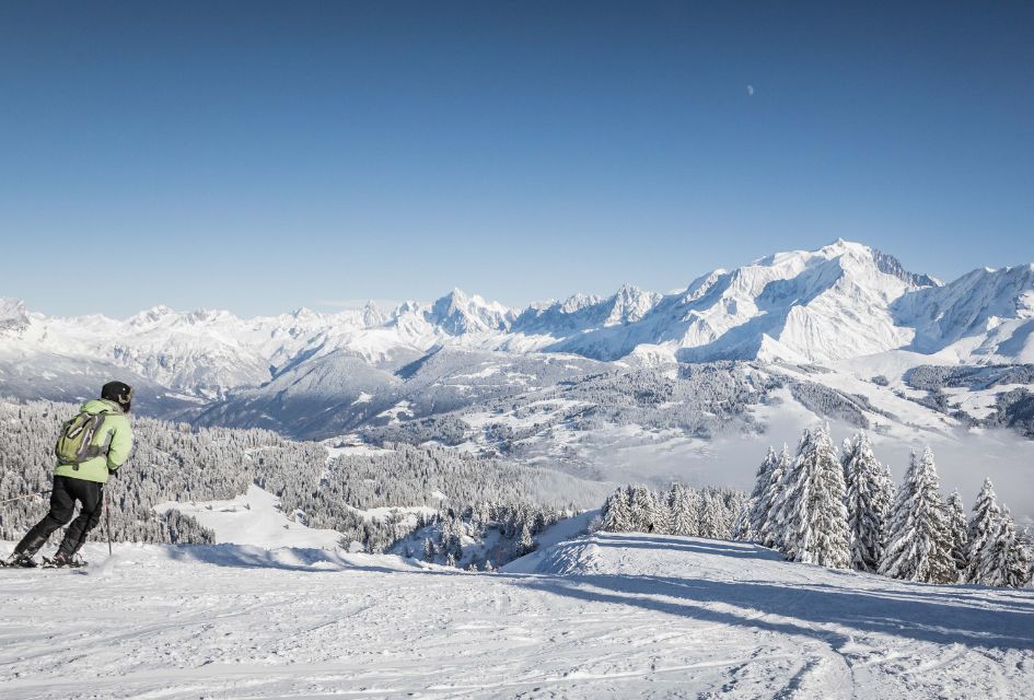 Skier on the quiet slopes in Megève, with snowy mountains and trees all around.